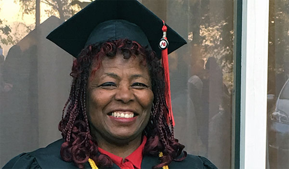 Charlotte "Sista C" Ferrell smiling at the Arts Institute of California Graduation Day after graduating with honors
